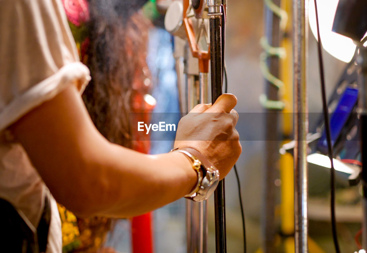 Cropped hand of woman holding pole