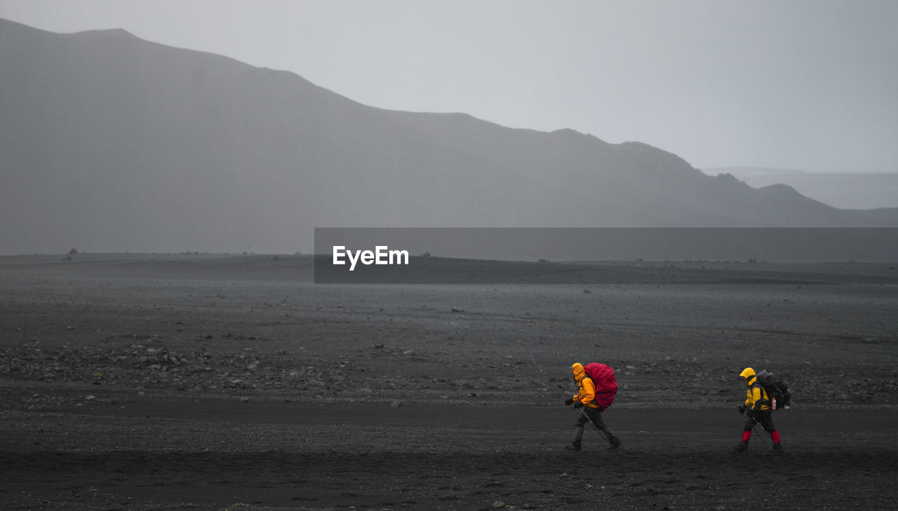 Two hikers in bad weather on the laugavegur hiking trail