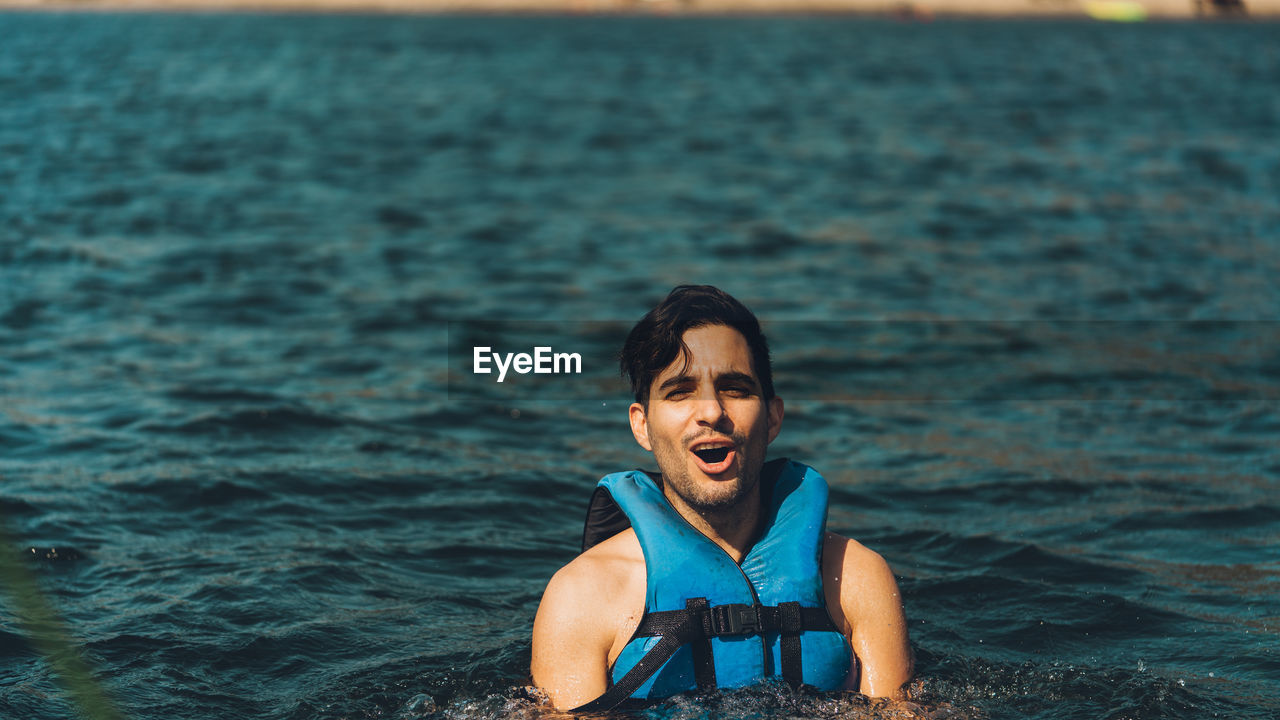 Portrait of young man in sea