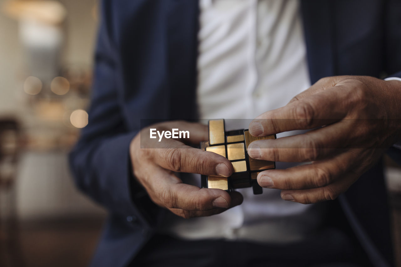 Close-up of businessman with rubik's cube
