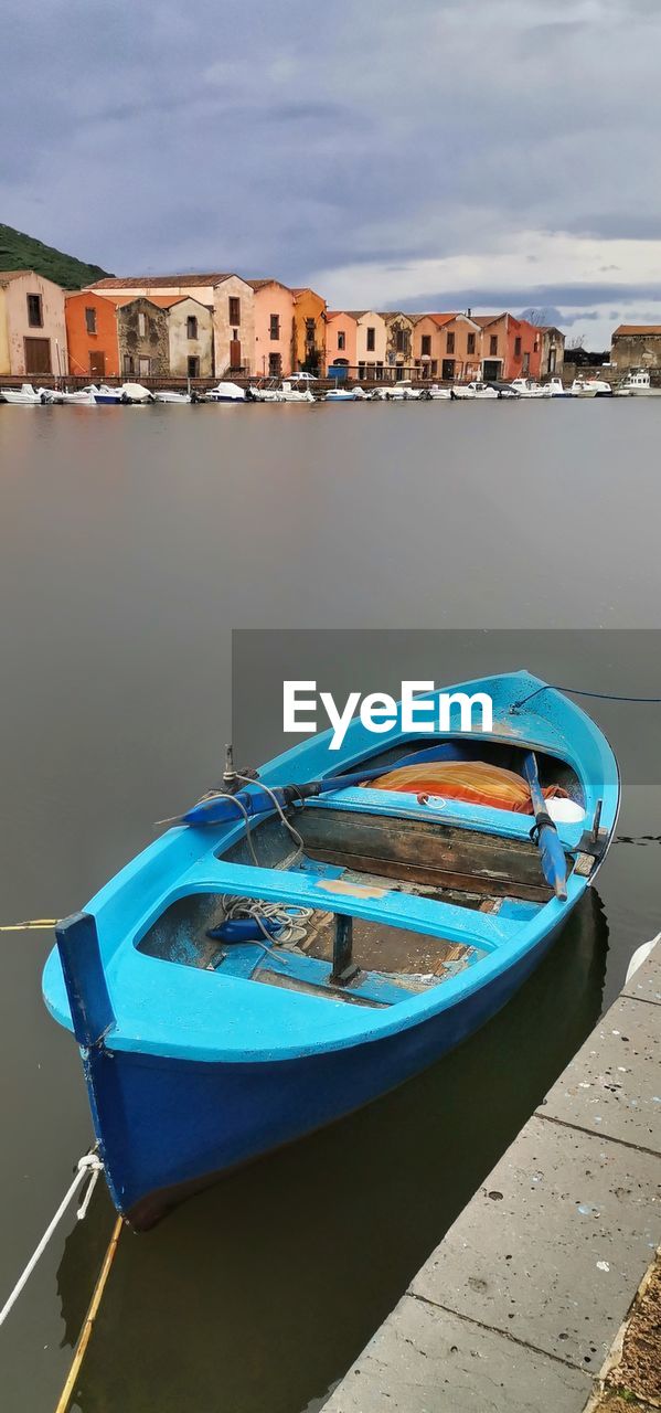 water, nautical vessel, transportation, architecture, vehicle, boat, building exterior, mode of transportation, nature, moored, sea, built structure, sky, travel destinations, city, beach, travel, no people, building, land, watercraft, tranquility, day, cloud, reflection, outdoors, pier, harbor, tourism, blue, beauty in nature, boating, sunlight, residential district, rowboat, tranquil scene, house, town, scenics - nature, trip, vacation