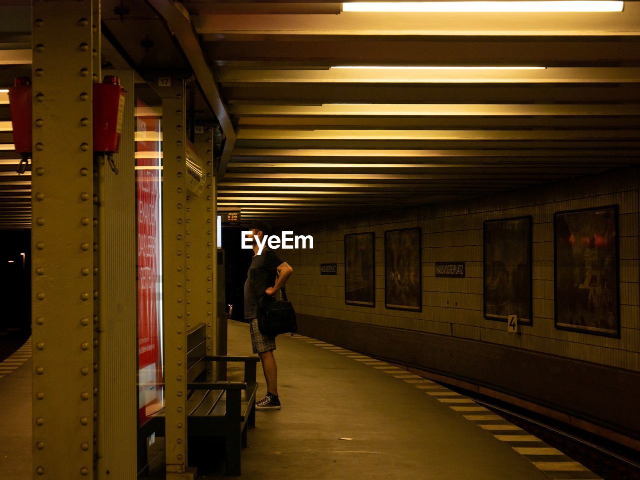 MAN STANDING ON SUBWAY STATION