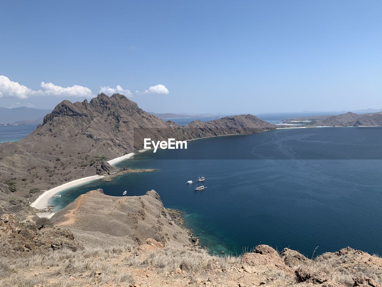 Scenic view of sea and mountains against sky