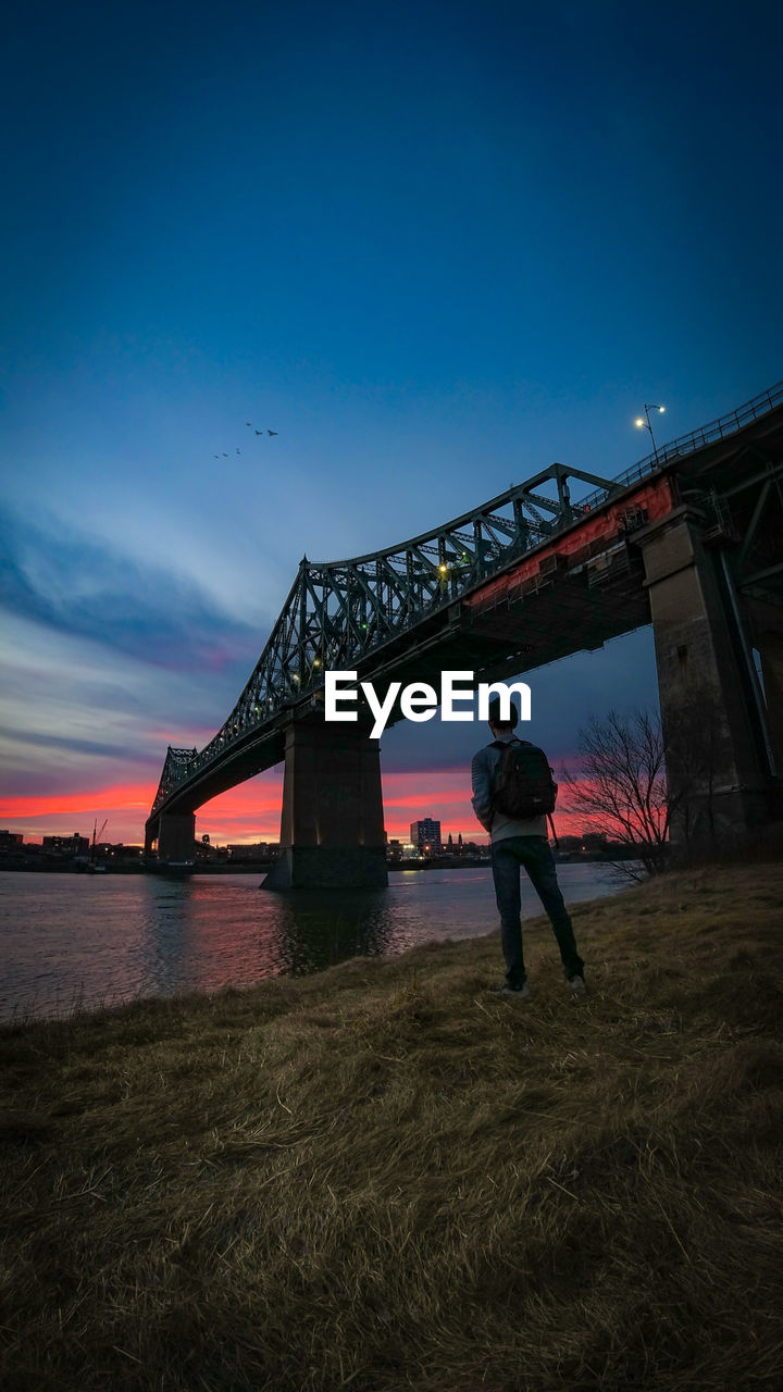 Full length of man standing on bridge against sky