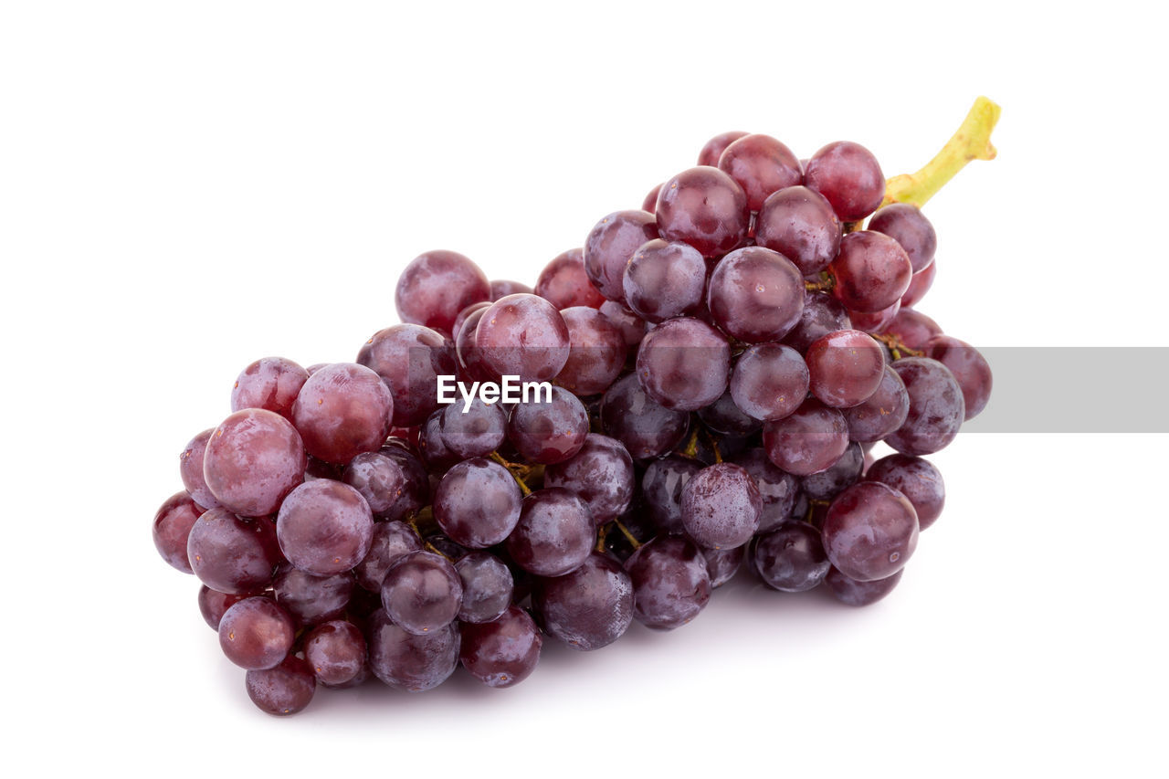 Close-up of grapes over white background