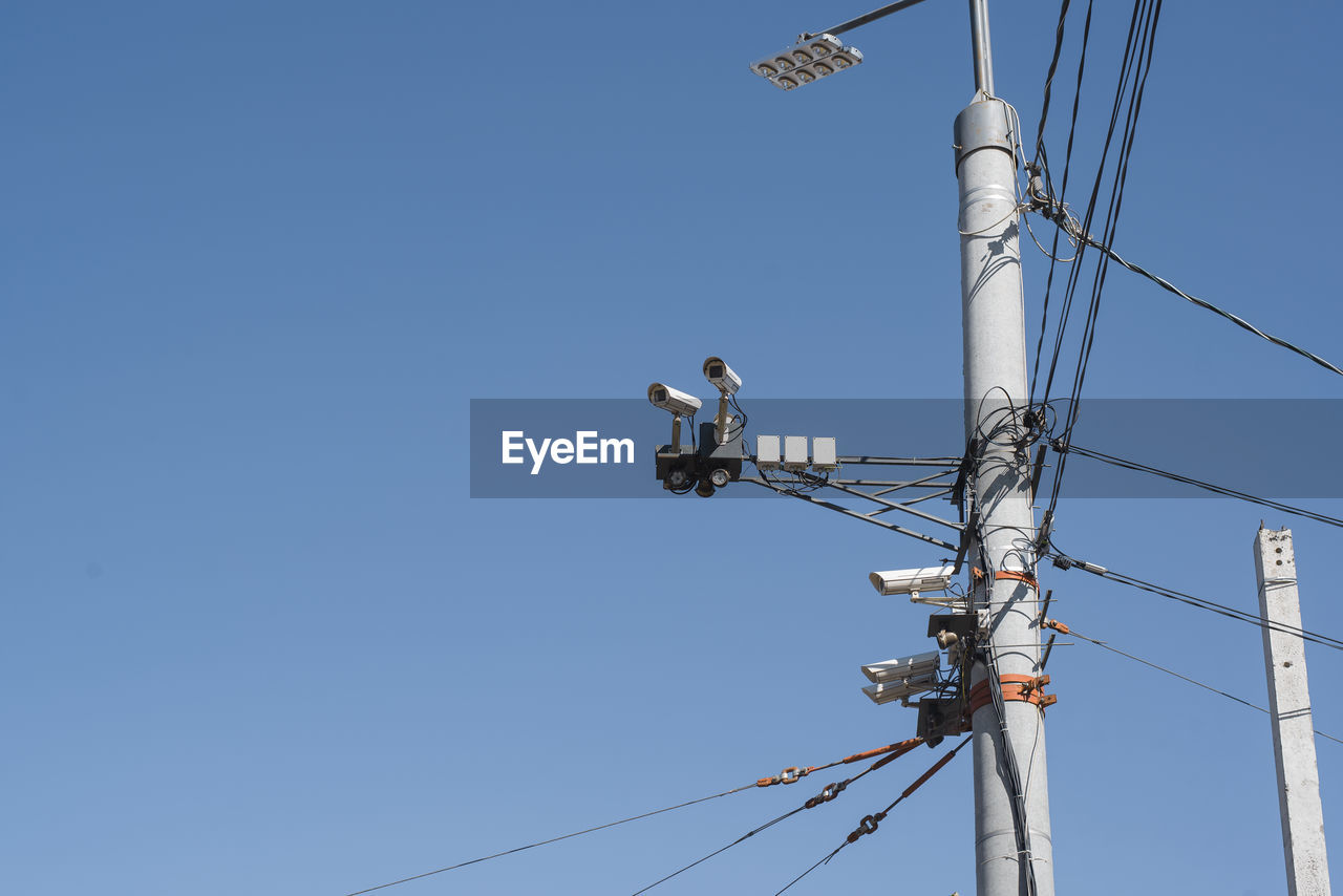 low angle view of security camera against clear sky