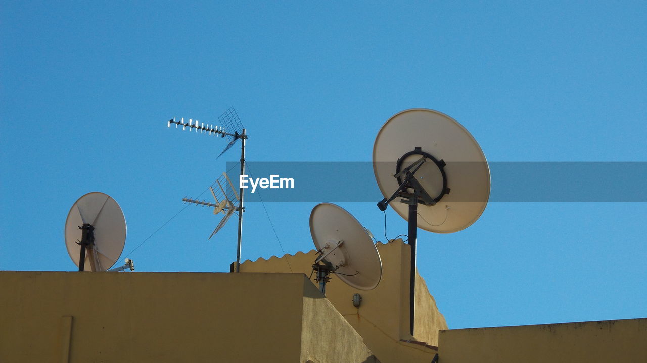 Television satellites dish on roof