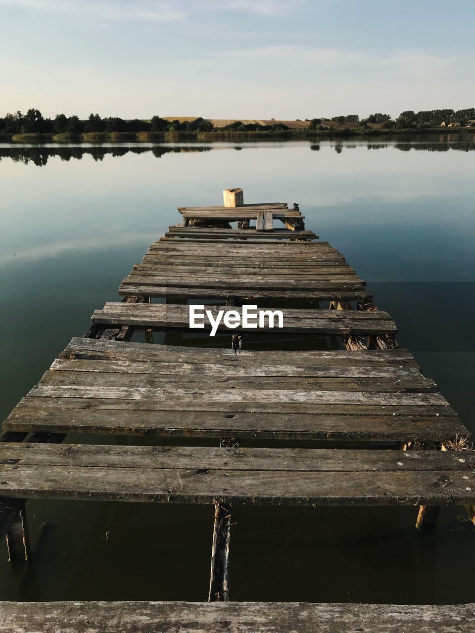 Pier on lake against sky