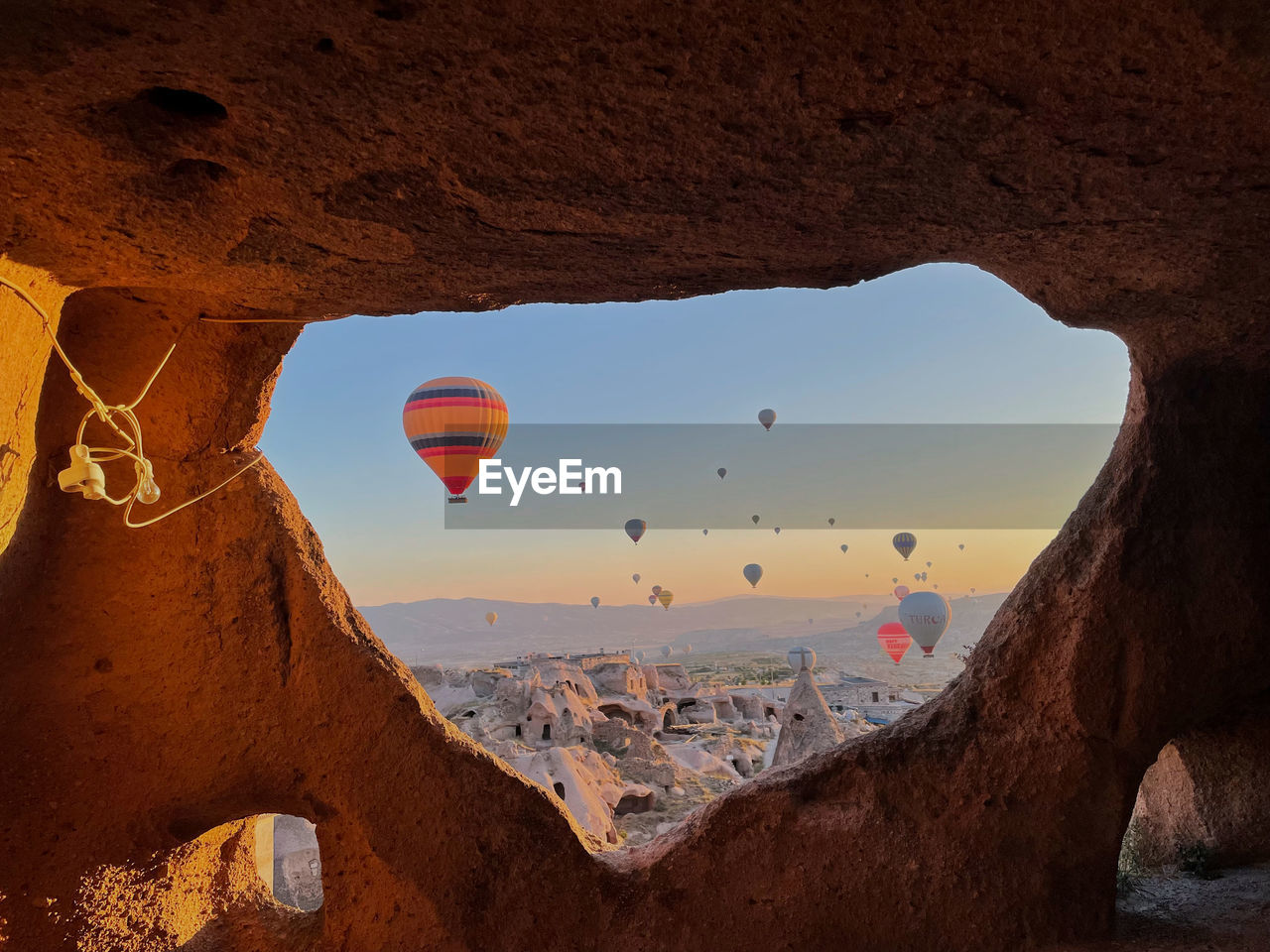 View of hot air balloon flying over rock