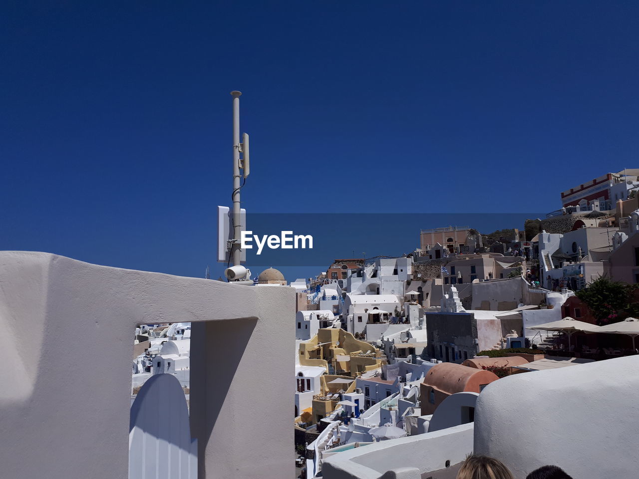 Buildings in city against clear blue sky