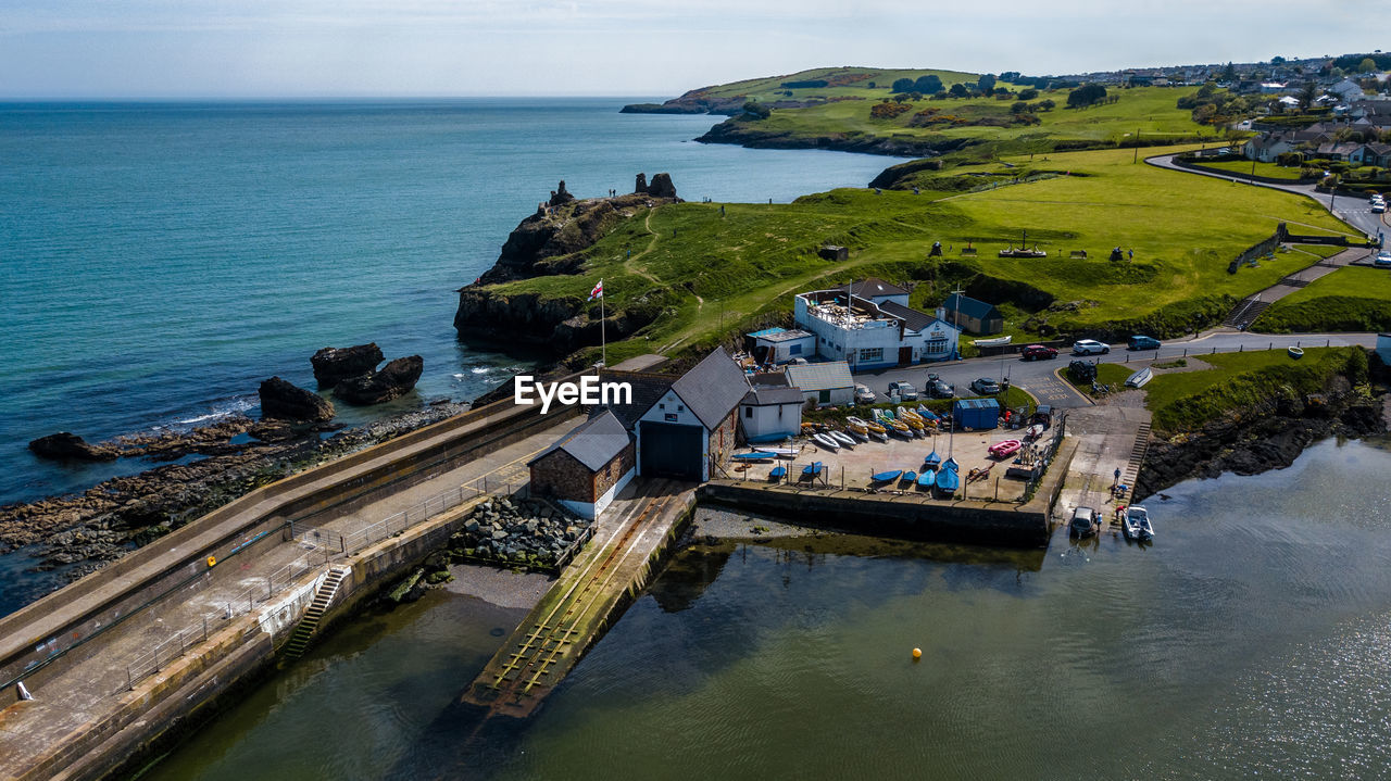 High angle view of houses in town against sea