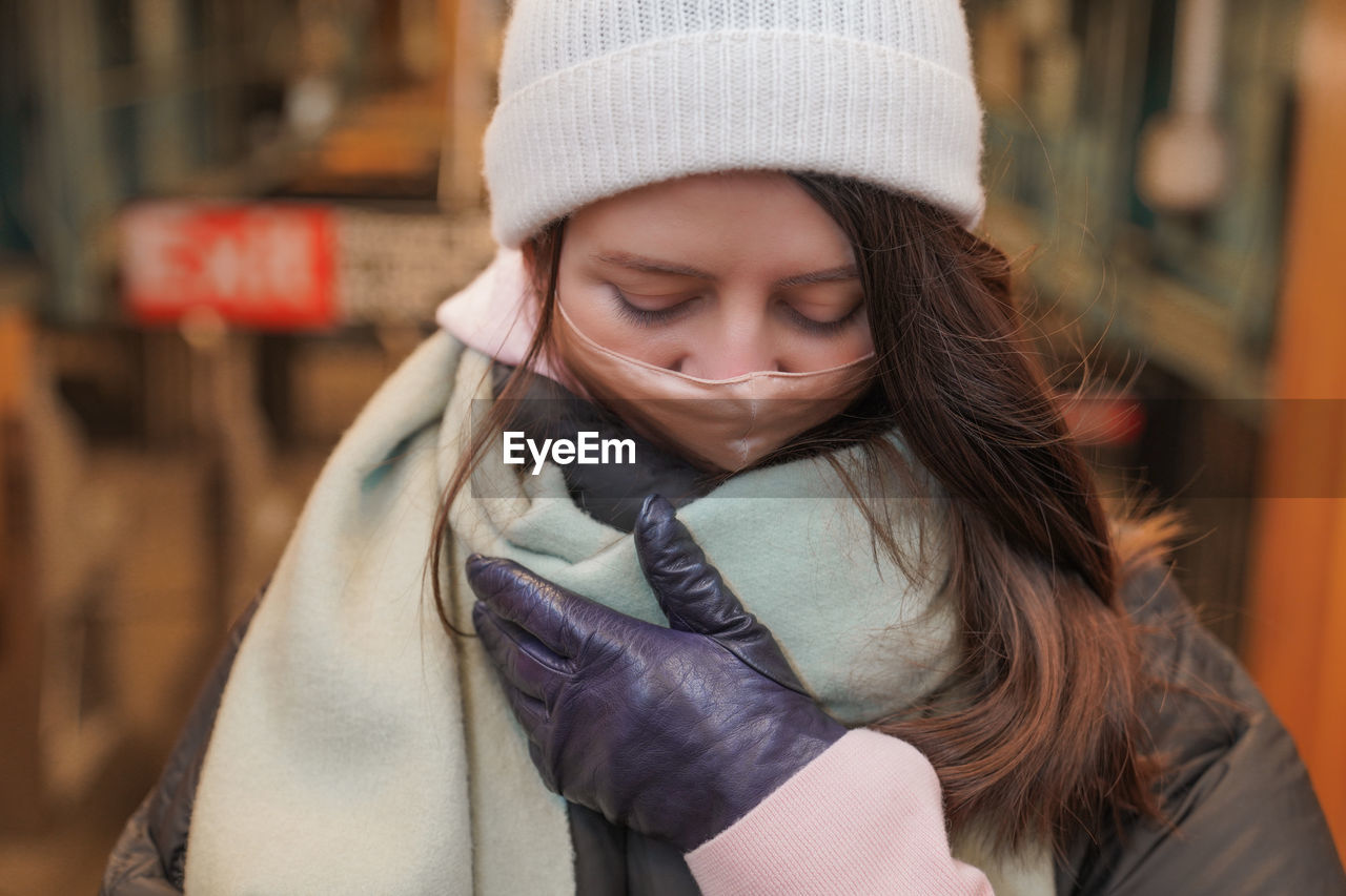 Woman wearing mask and warm clothing