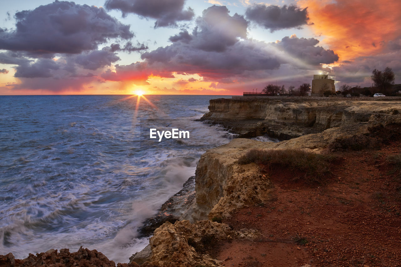 SCENIC VIEW OF SEA AGAINST ORANGE SKY