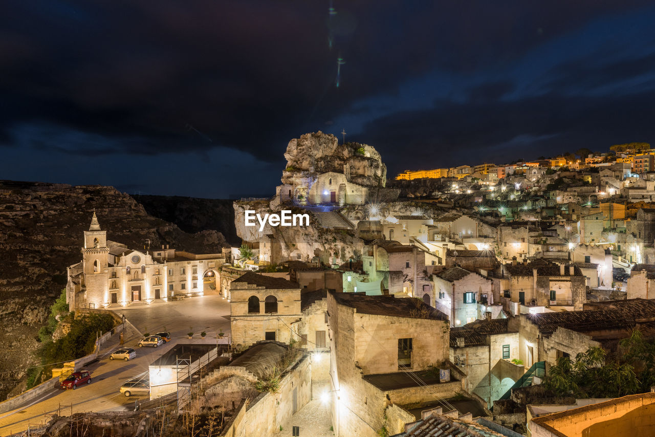 Illuminated sassi di matera against sky at night