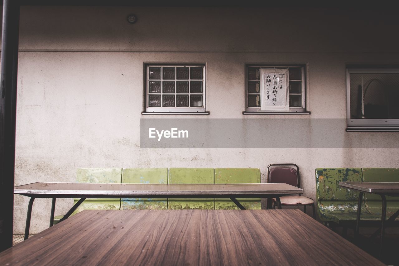 Empty chairs and tables in building