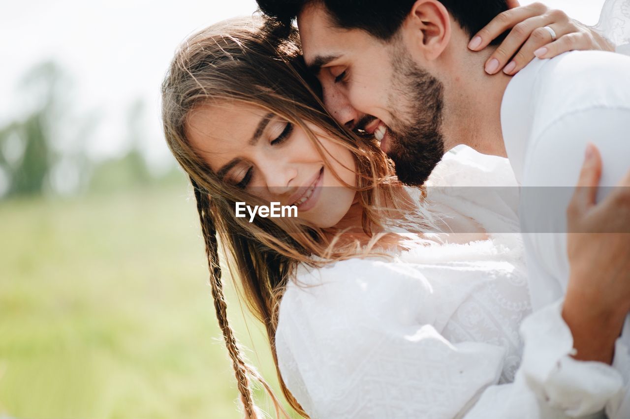 Close-up of young couple romancing outdoors