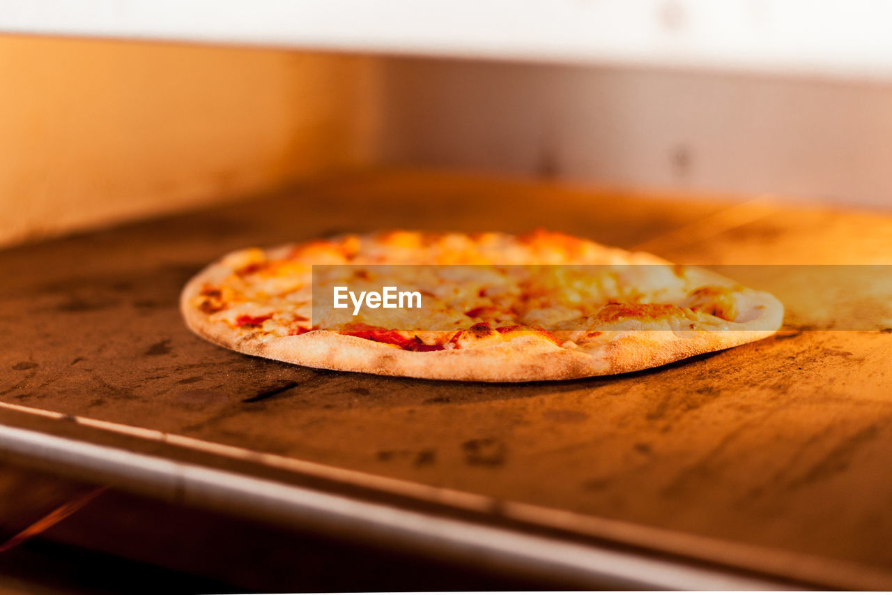 Close-up of pizza slice in oven