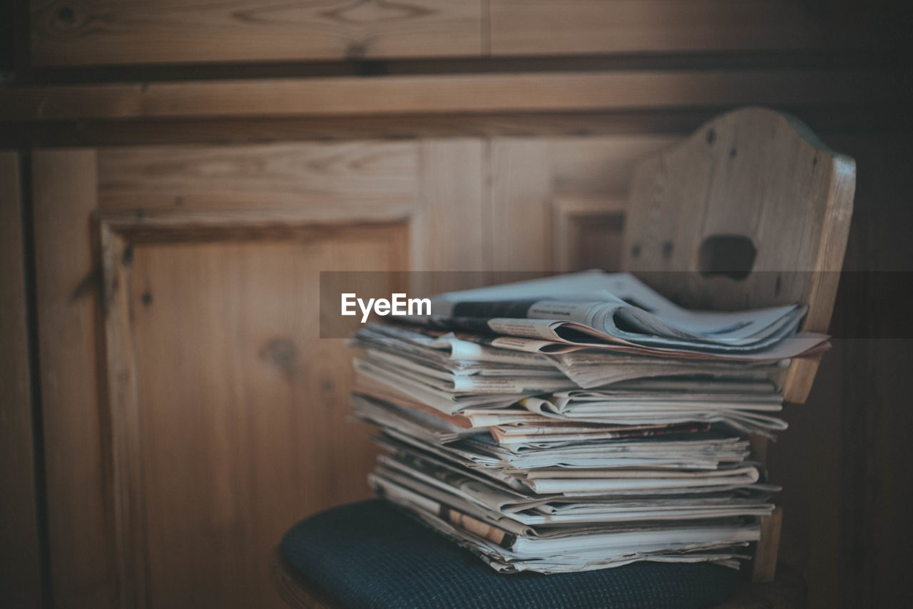 Stack of newspapers on table