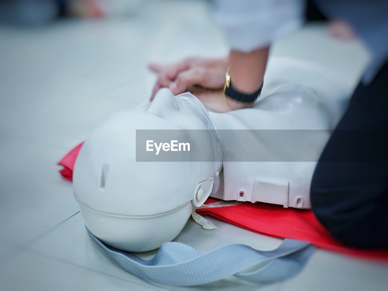 Midsection of person with cpr dummy during training