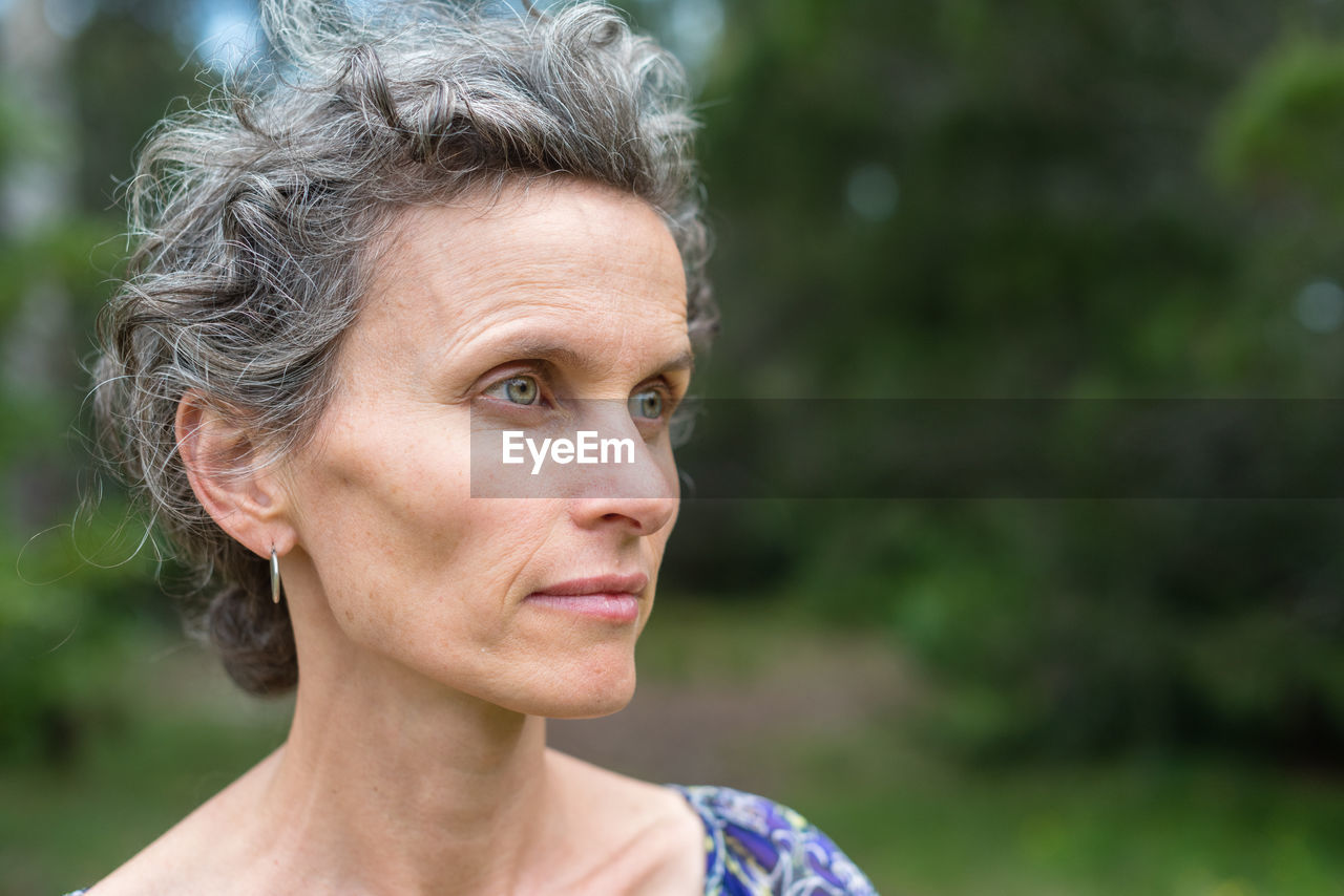 Close-up of thoughtful mature woman looking away