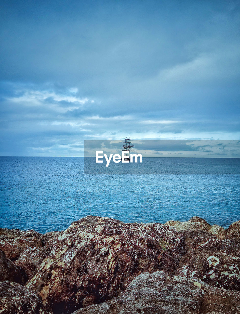 SCENIC VIEW OF SAILBOAT IN SEA AGAINST SKY