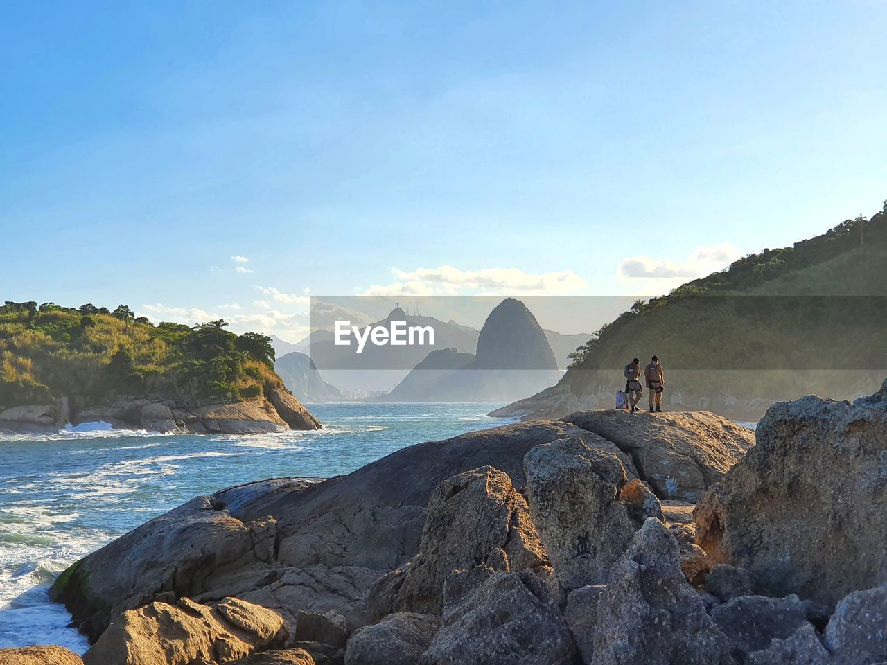 Panoramic shot of rocks in sea against sky