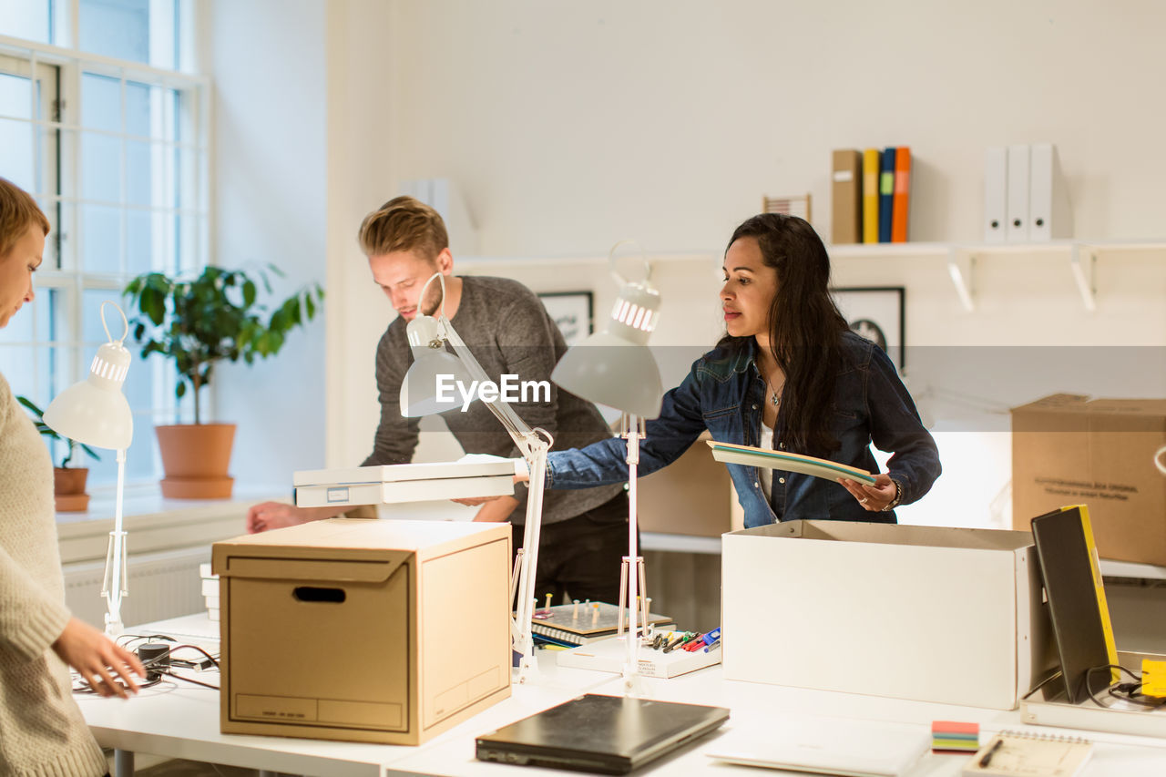 Multi-ethnic business colleagues working at illuminated creative office