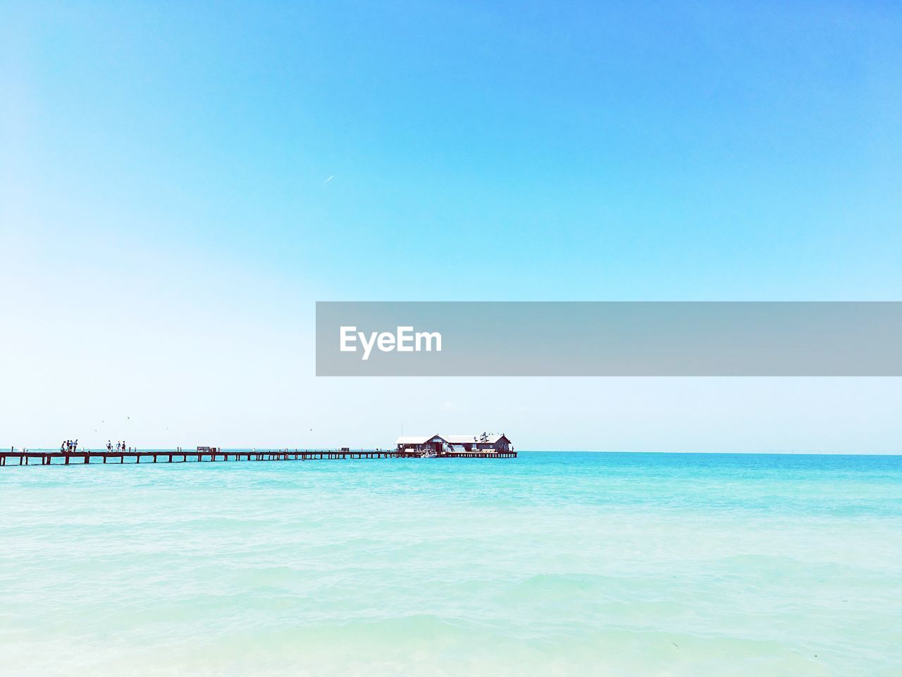 Scenic view of sea against clear blue sky