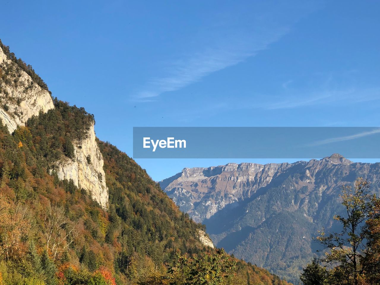 Scenic view of mountains against blue sky