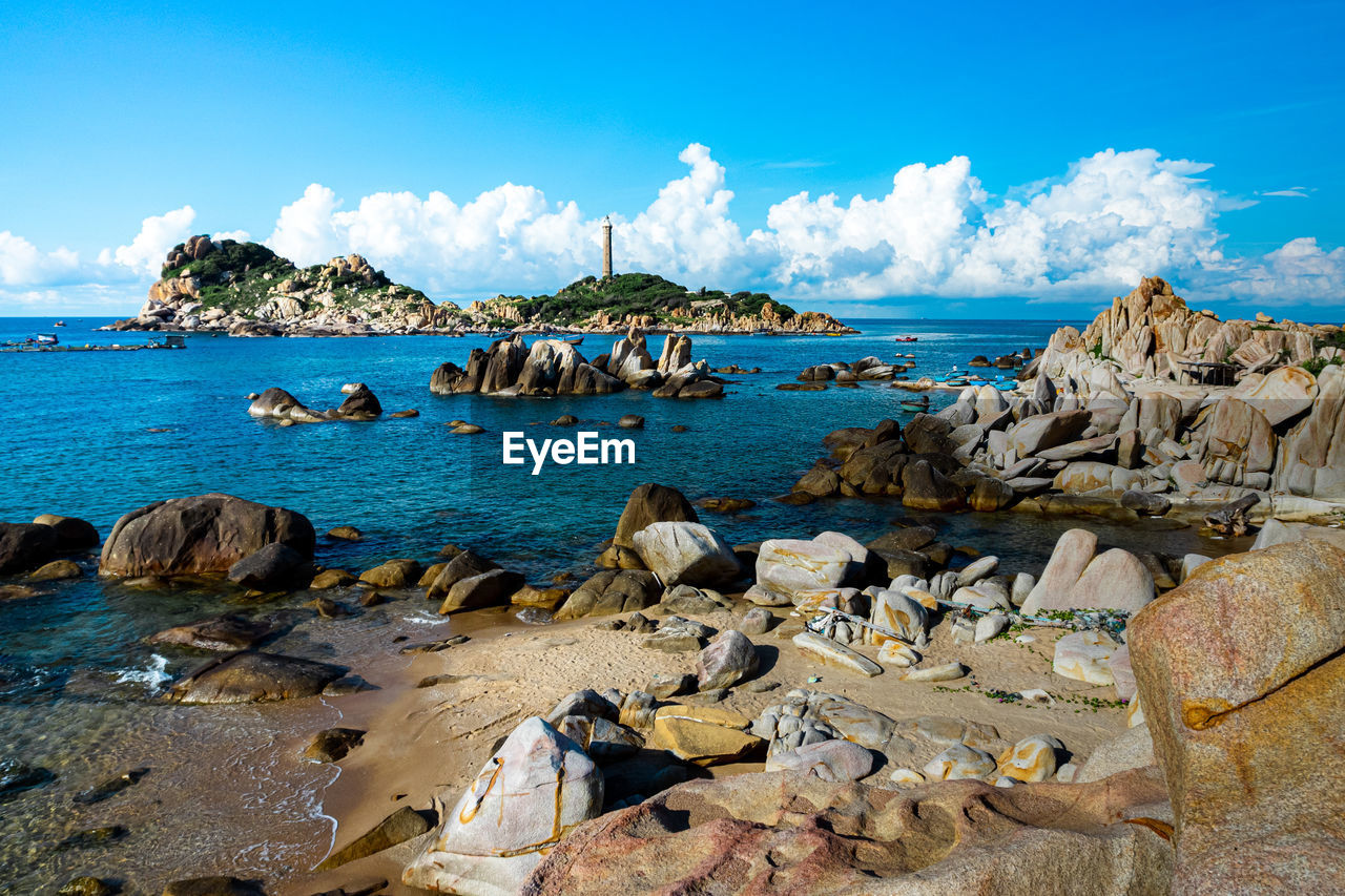 Panoramic view of rocks on beach against sky