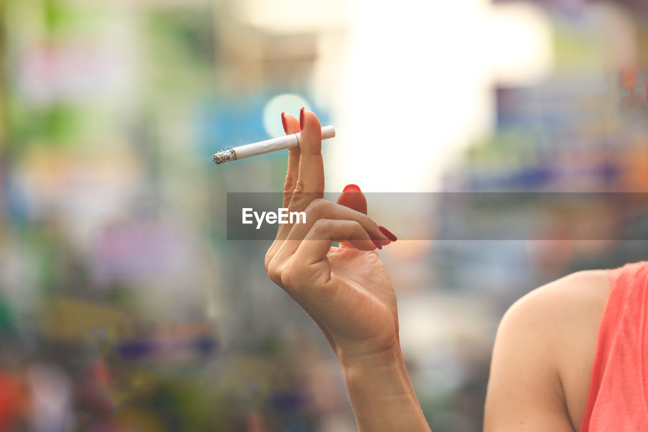 Woman hand holding cigarette