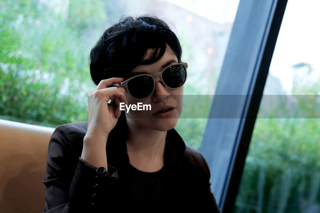 Portrait of young woman in sunglasses