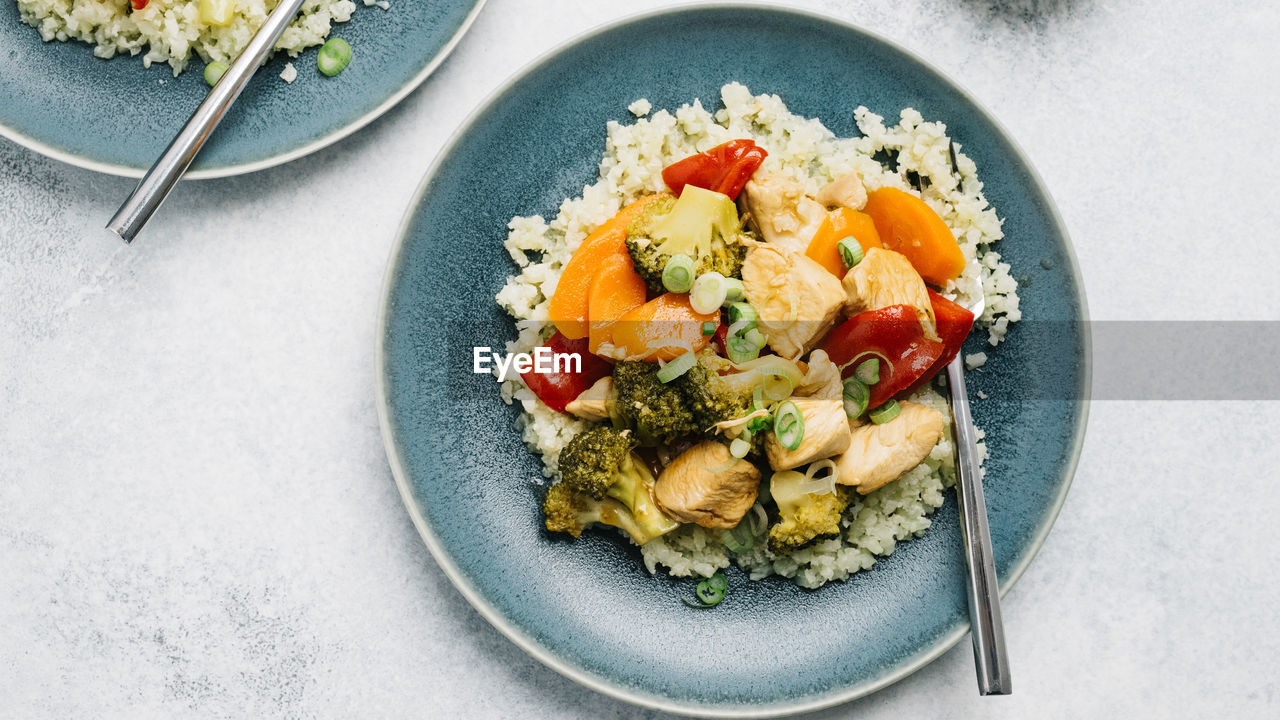 Paleo sweet and sour chicken over cauliflower rice flatlay