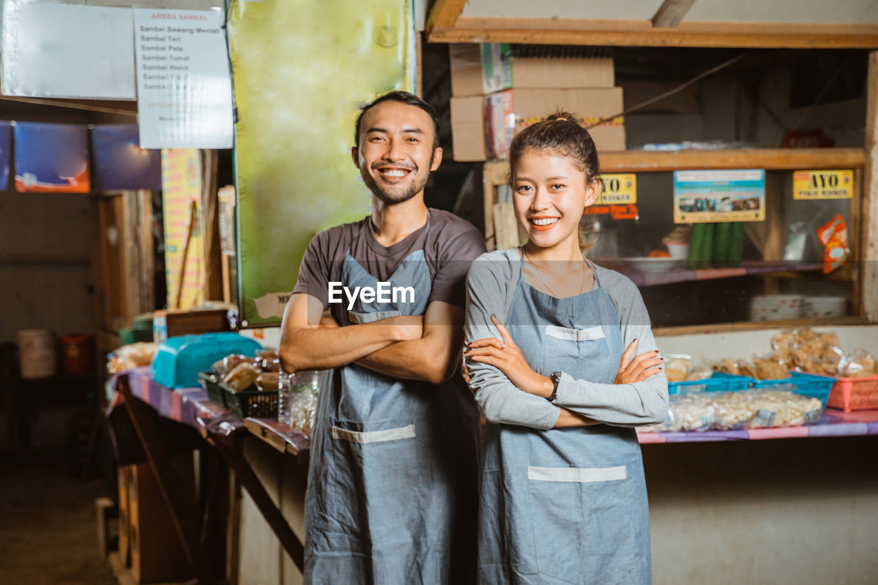 portrait of smiling friends standing in market