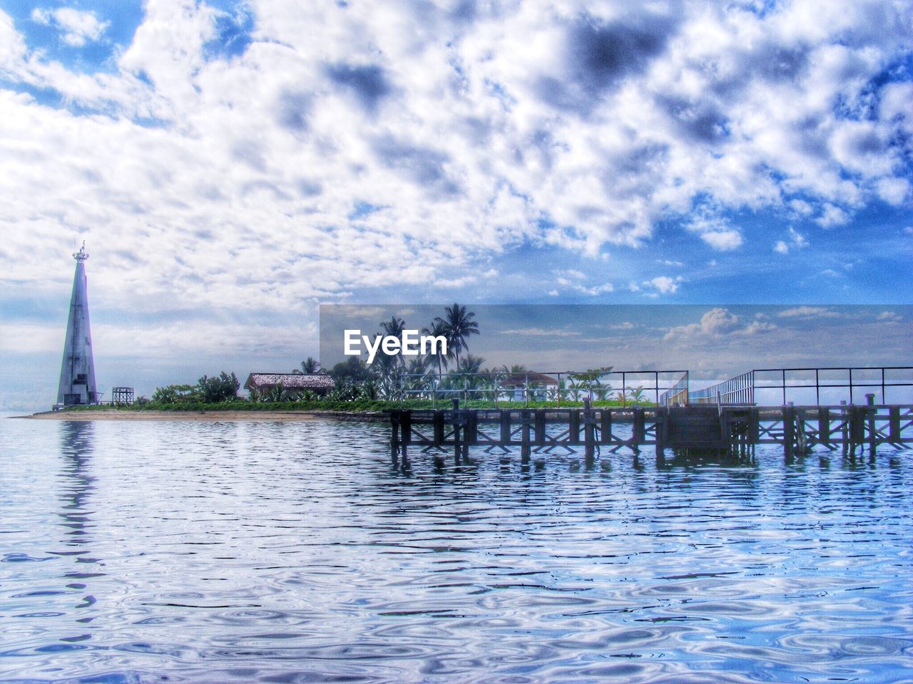 VIEW OF RIVER WITH CITY IN BACKGROUND