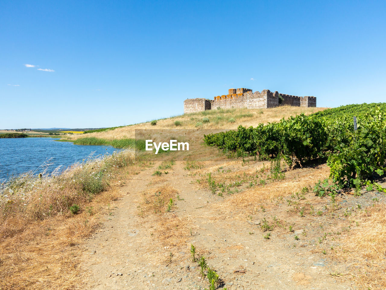 BUILT STRUCTURE ON LAND AGAINST BLUE SKY