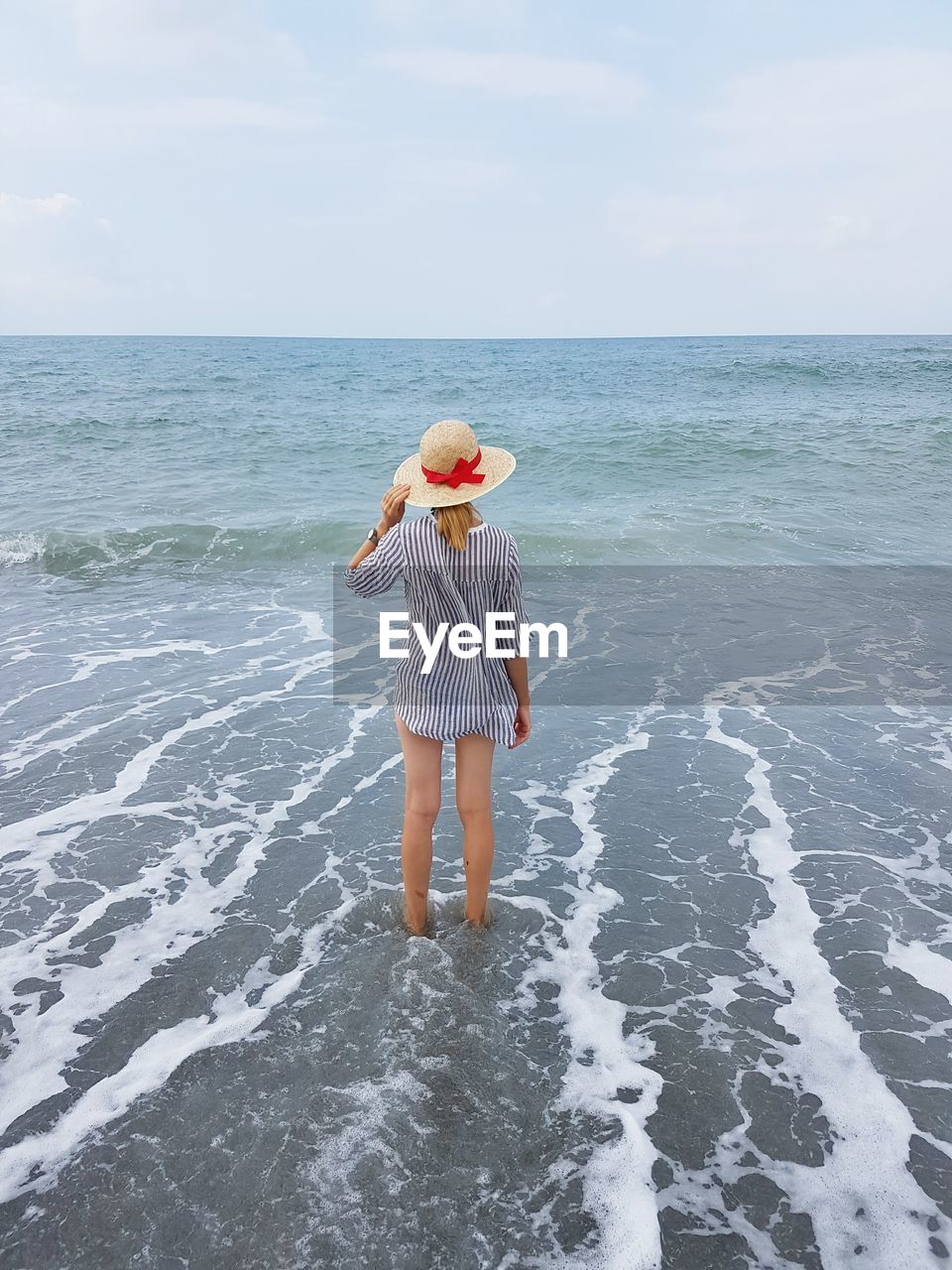 Woman on beach against sky