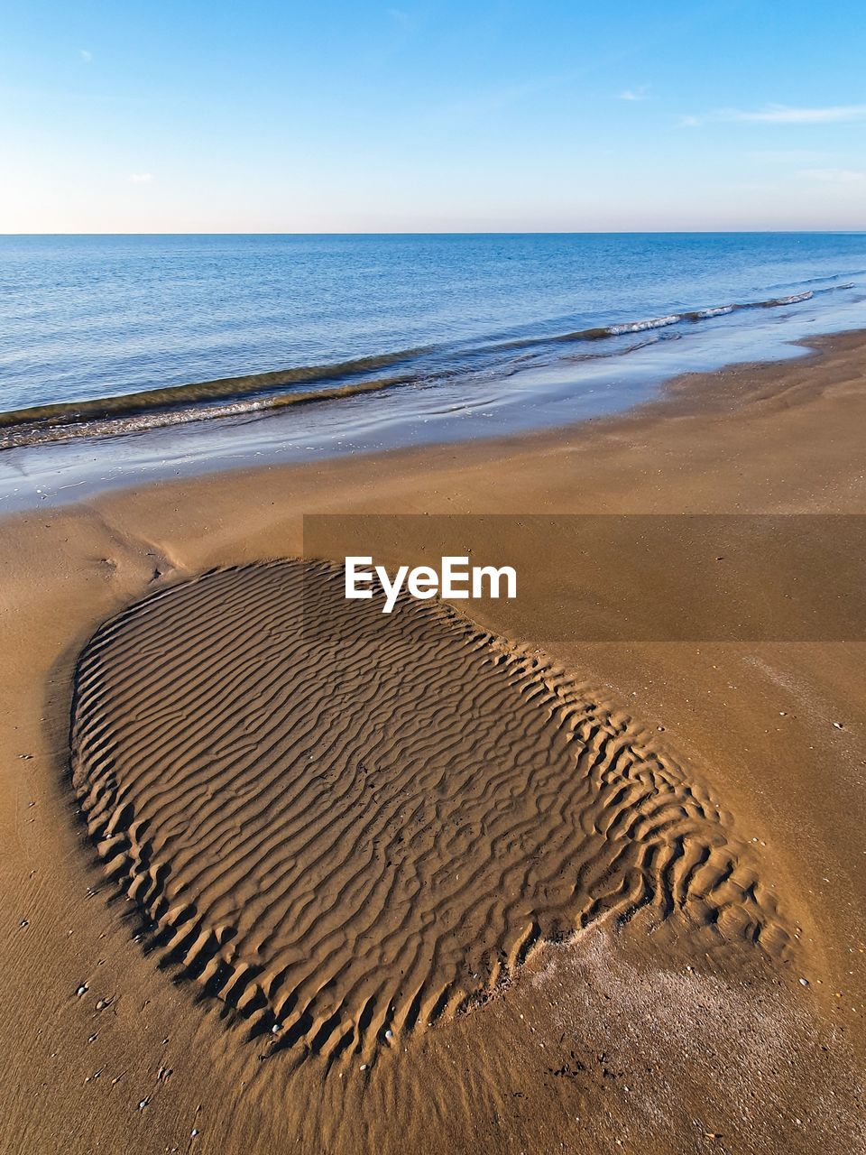 Low tide outflow marks on a sandy beach