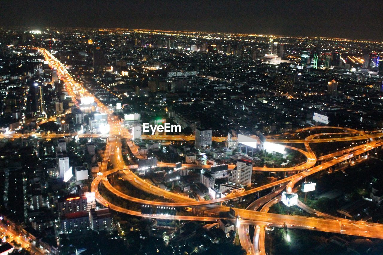 HIGH ANGLE VIEW OF CITY AT NIGHT