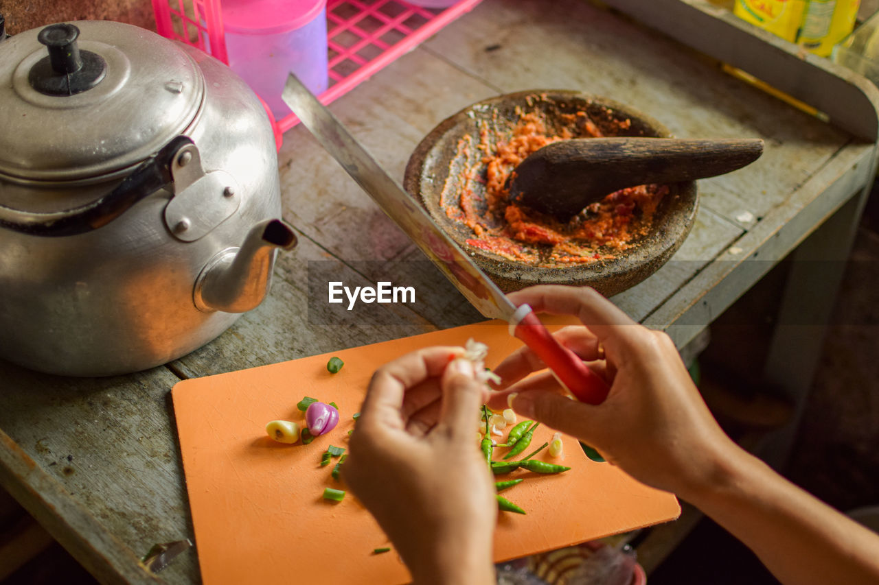 High angle view of woman preparing food on table