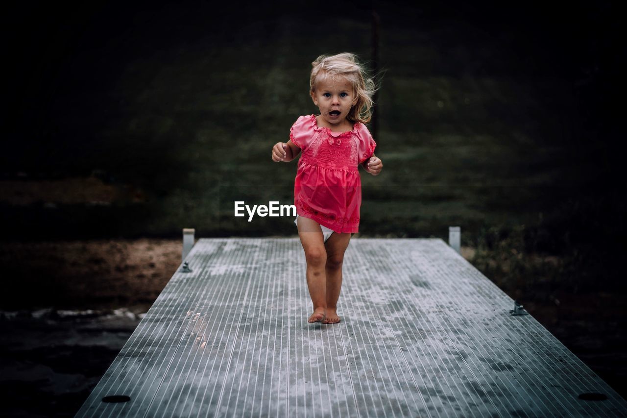 Portrait of girl walking on jetty