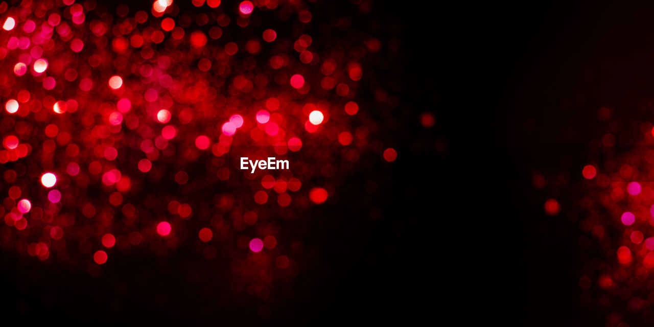 Defocused image of illuminated red lights at night