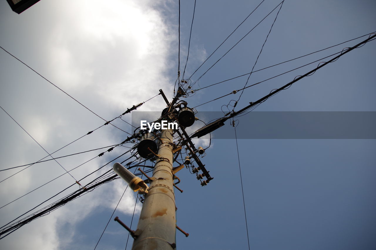 Low angle view of electricity pylon against sky