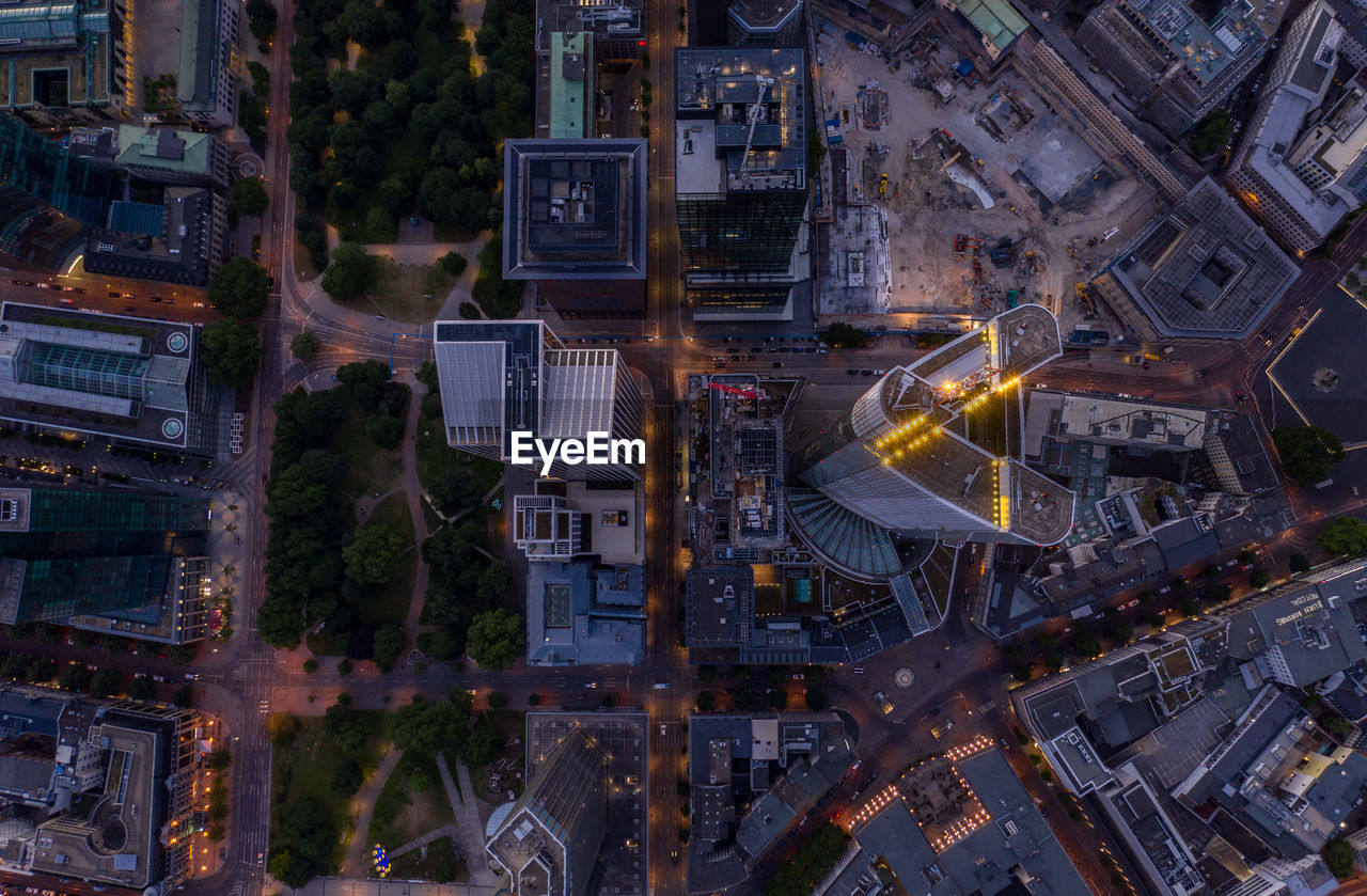 HIGH ANGLE VIEW OF STREET AMIDST BUILDINGS IN CITY AT NIGHT