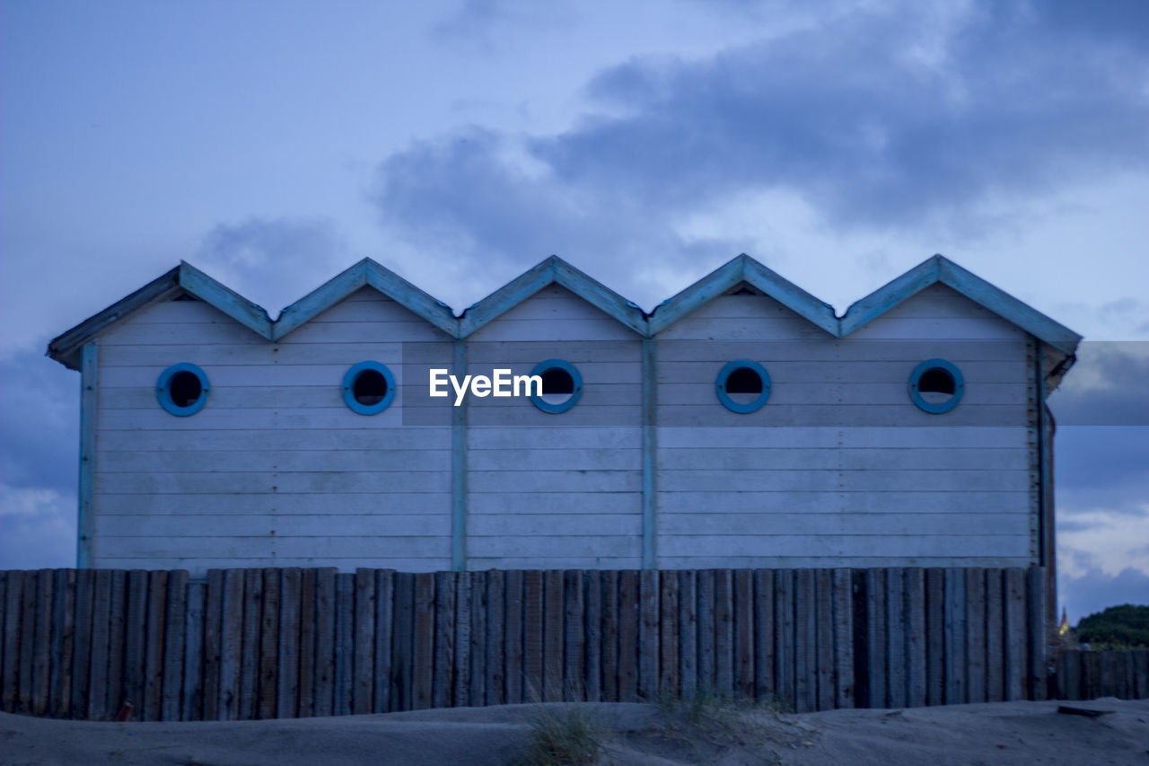 Built structure on beach against sky