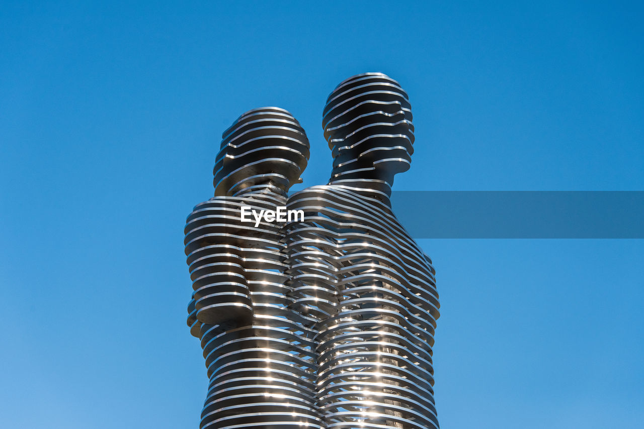 LOW ANGLE VIEW OF BUILT STRUCTURE AGAINST BLUE SKY AND CLEAR BACKGROUND