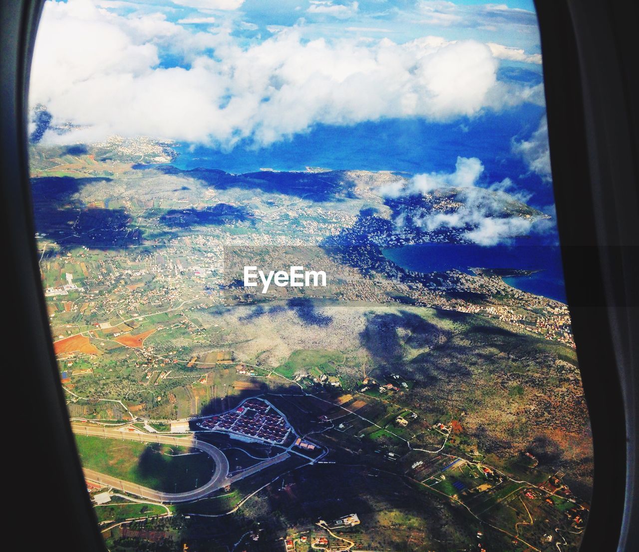 CLOUDSCAPE SEEN THROUGH AIRPLANE WINDOW