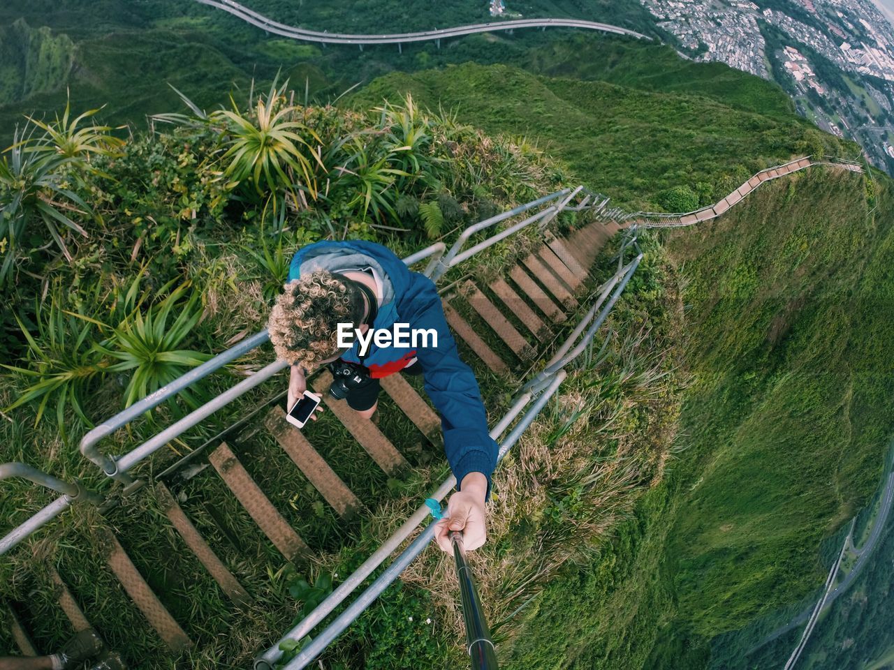 High angle view of man on haiku stairs at oahu