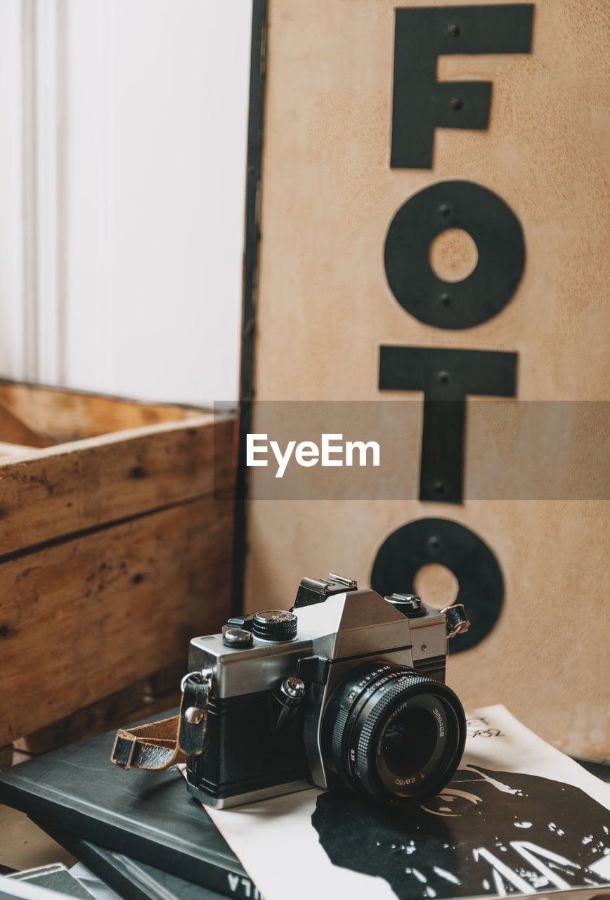 Vintage film camera on shelf in retro photo studio