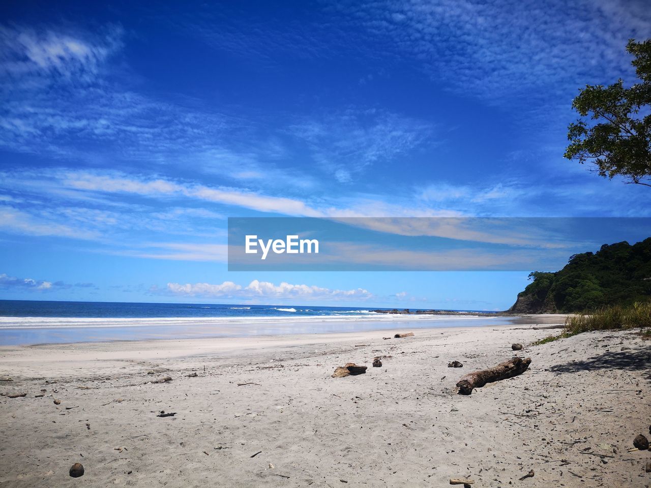 VIEW OF BEACH AGAINST BLUE SKY